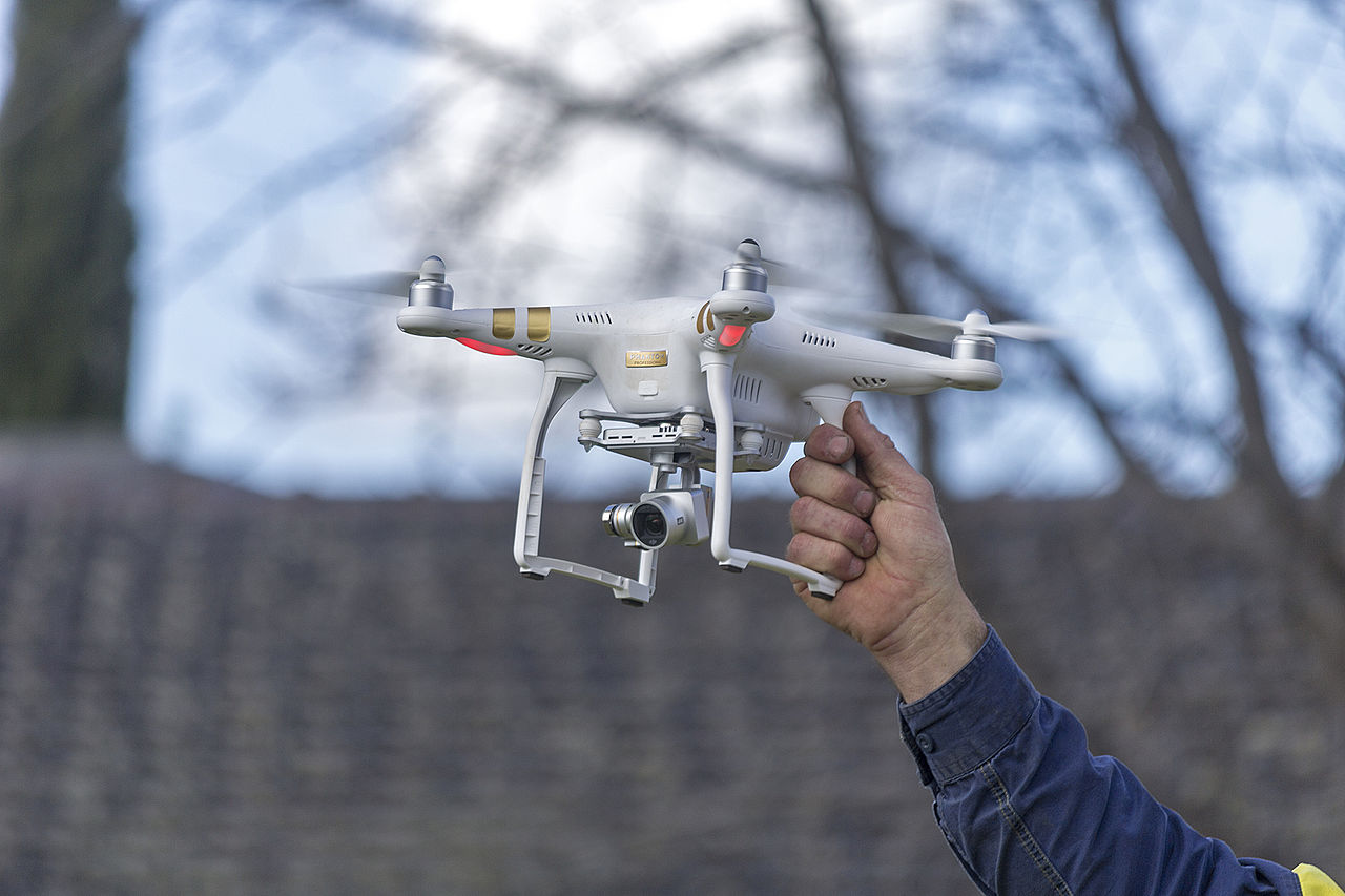 Holding a drone up to show scale